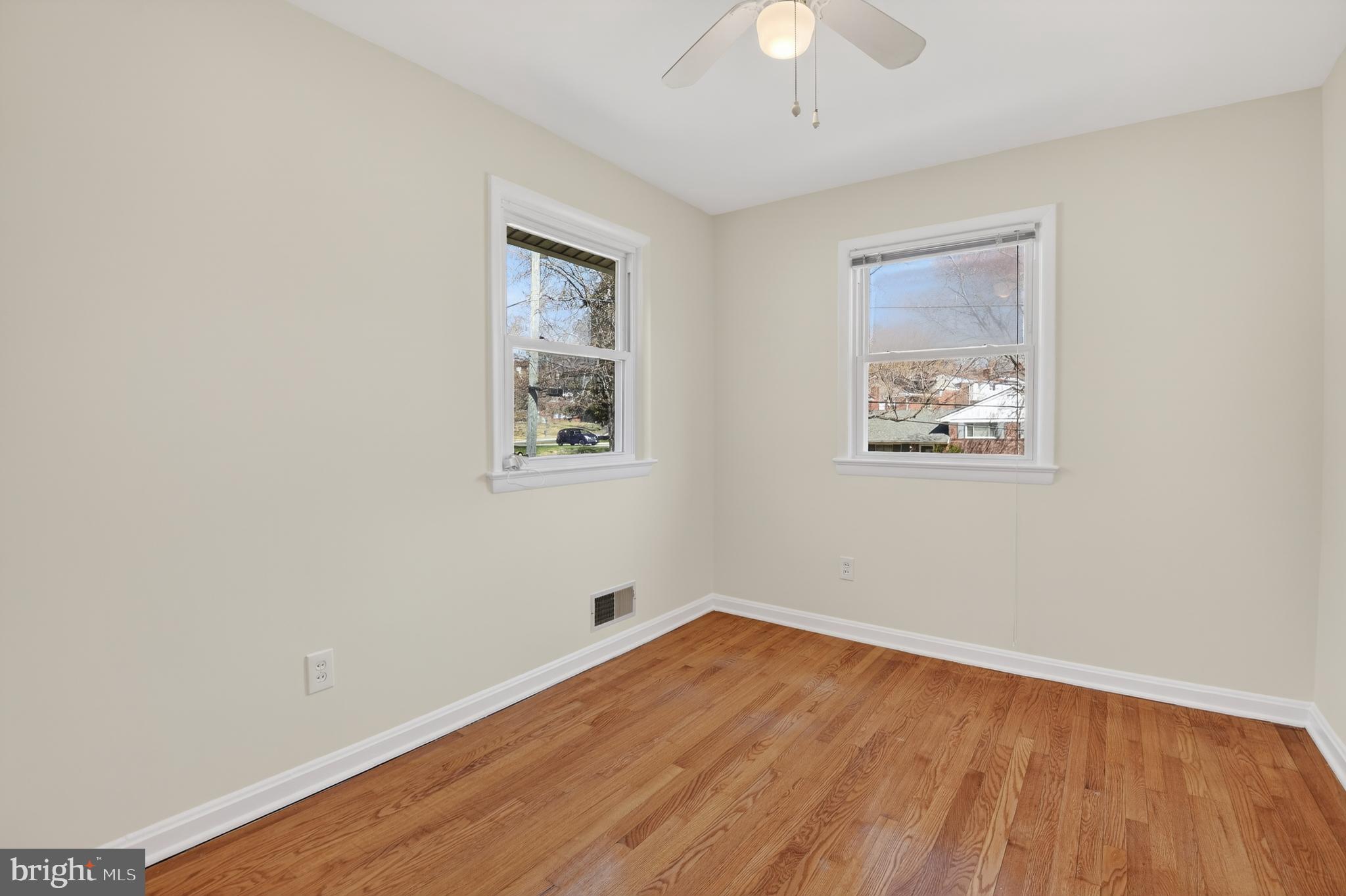 11004 Oakwood Street Silver Spring, MD 20901 - Photo 22 of 35 a view of empty room with wooden floor and fan