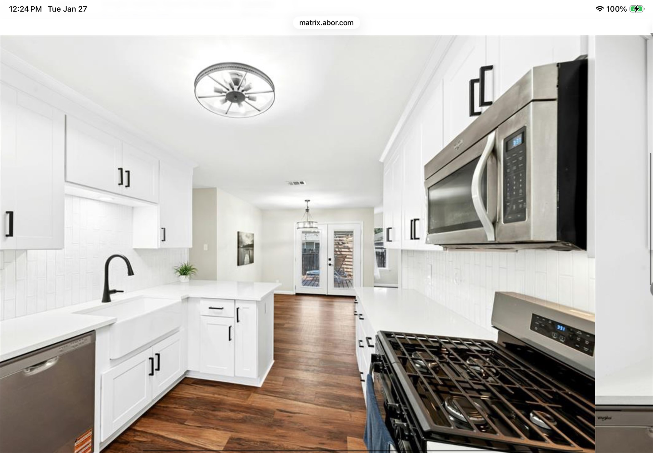 12904 Garfield Lane Austin, TX 78727 - Photo 16 of 31 Kitchen featuring new stainless steel appliances, white 42”cabinetry, and LVP wood-type flooring