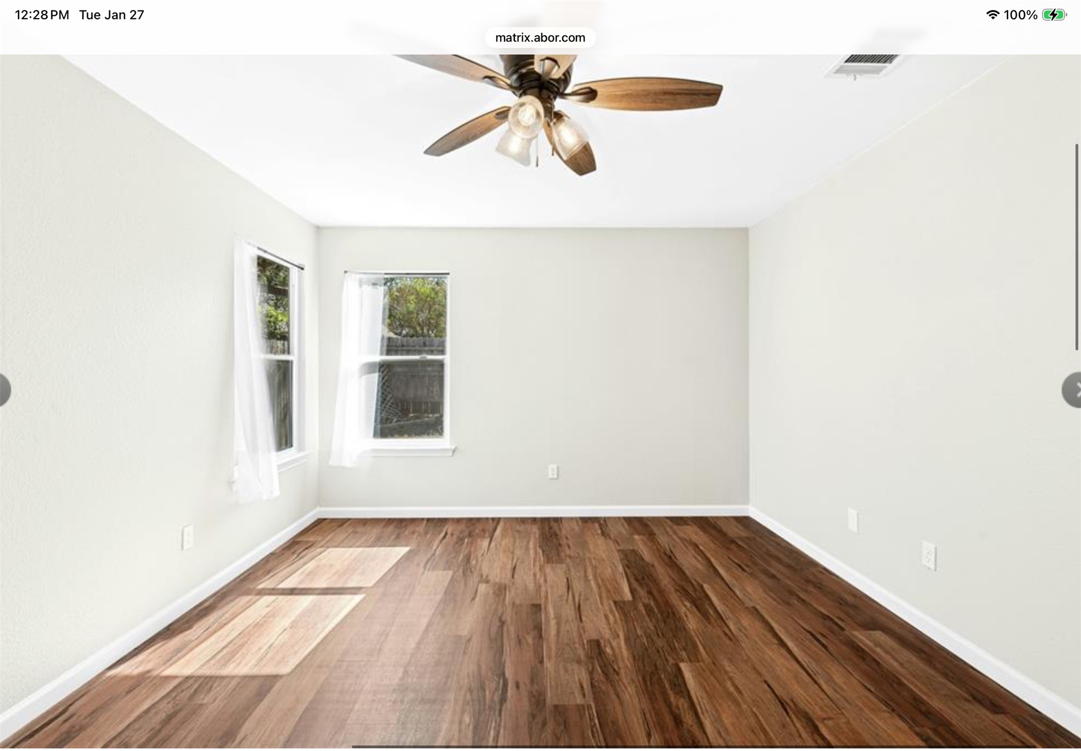 12904 Garfield Lane Austin, TX 78727 - Photo 19 of 31 Empty primary room featuring water resistant LVP wood-style floors, new ceiling fan/light fixture.