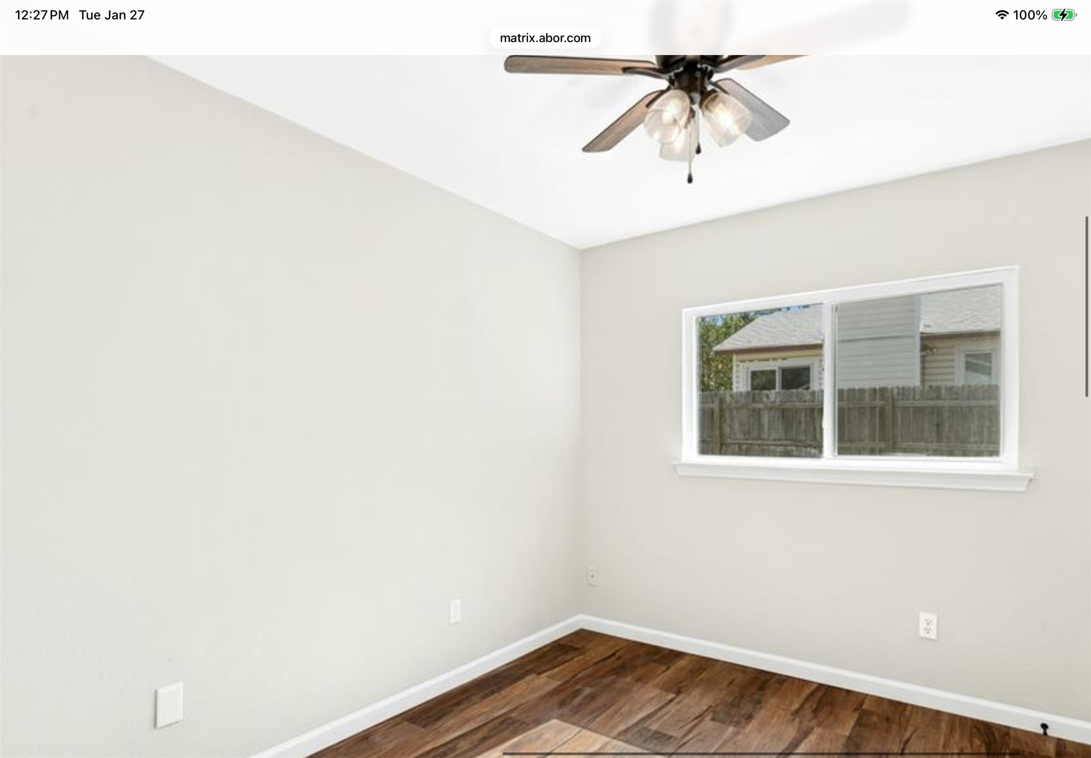 12904 Garfield Lane Austin, TX 78727 - Photo 22 of 31 Empty bedroom #2 featuring LVP wood-type flooring and new ceiling fan & light fixture.