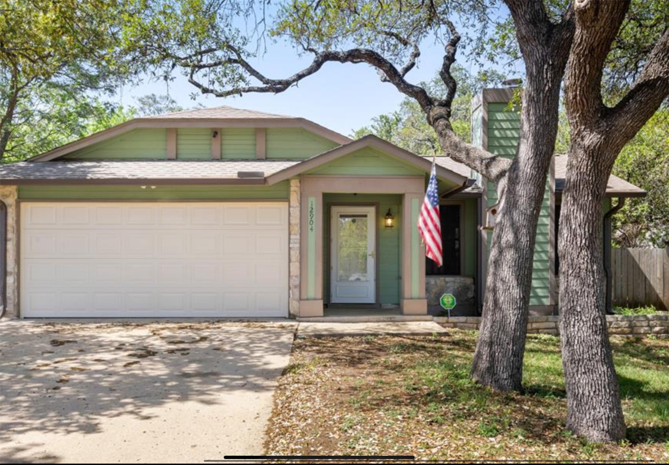 12904 Garfield Lane Austin, TX 78727 - Photo 9 of 31 View of front of home featuring driveway, an attached front entry garage. Roof has new shingles (September 2025).