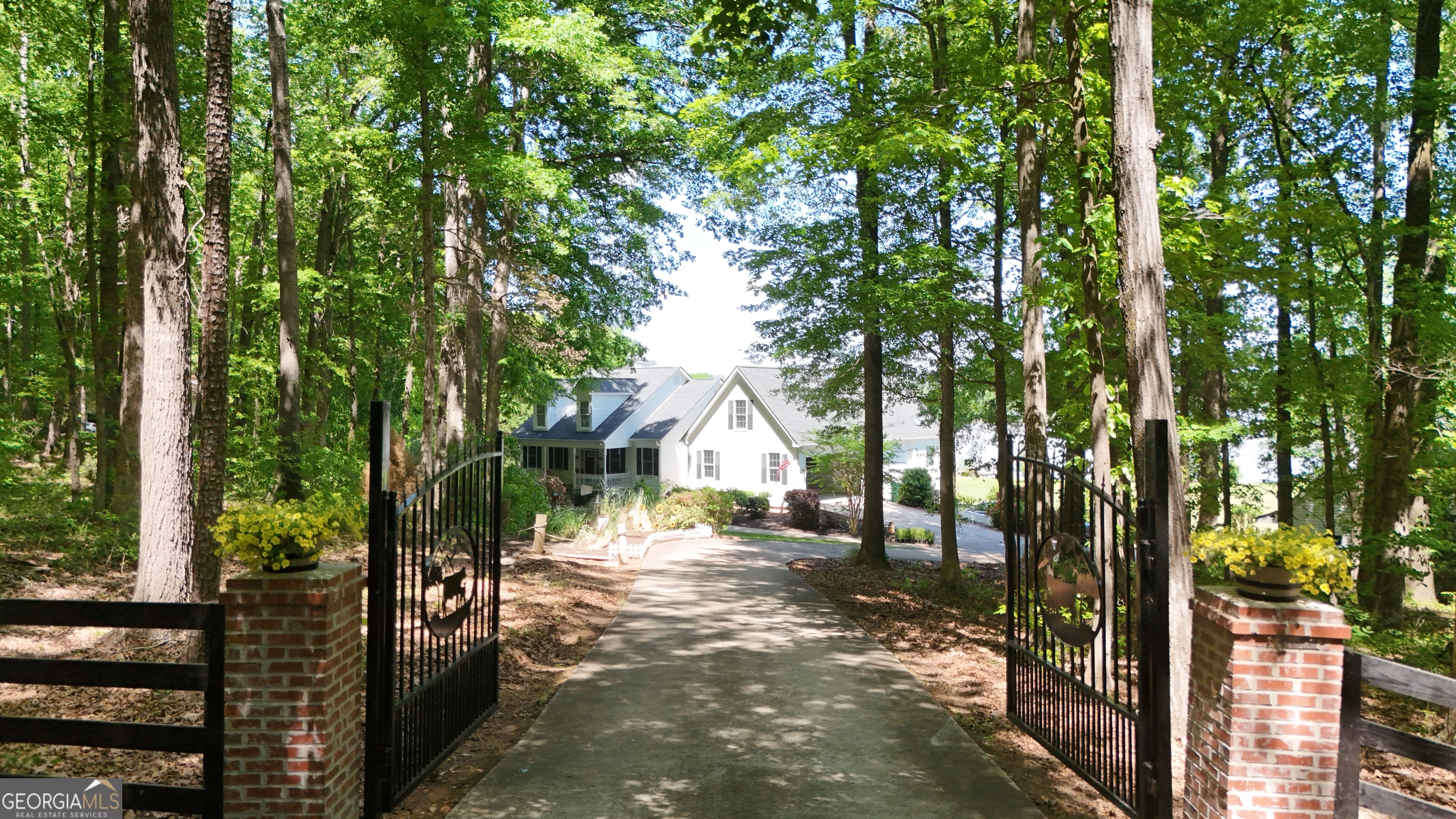 1051 Oconee Farms Road Greensboro, GA 30642 - Photo 18 of 23 a view of a house with a tree in the background