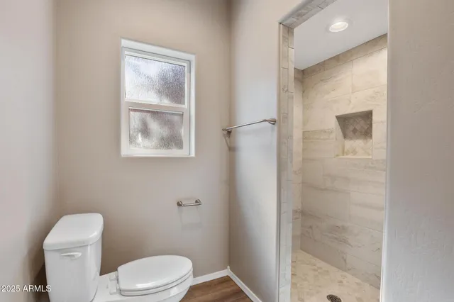 a white toilet sitting next to a bathroom sink