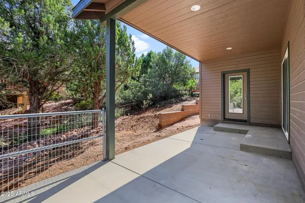 a view of a porch with furniture and floor to ceiling window