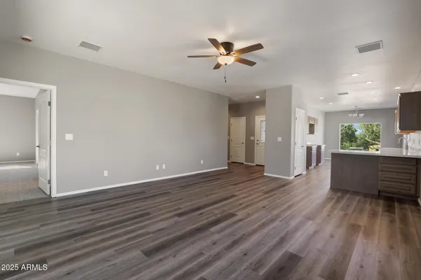 a view of an empty room and wooden floor