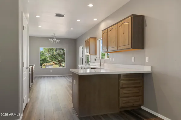a kitchen with a sink cabinets and wooden floor