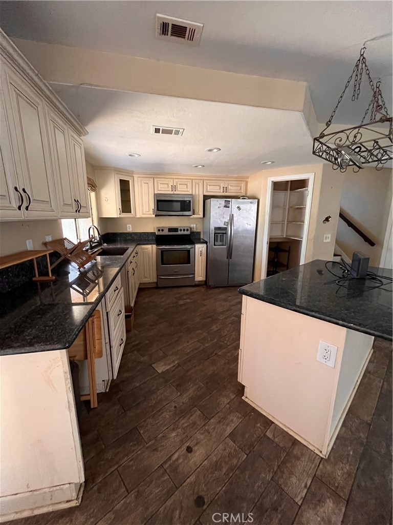24638 Pappas Road Ramona, CA 92065 - Photo 15 of 23 a large kitchen with a large counter top appliances and cabinets