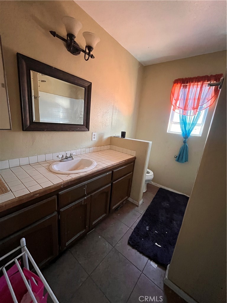 24638 Pappas Road Ramona, CA 92065 - Photo 9 of 23 a bathroom with a double vanity sink and a mirror