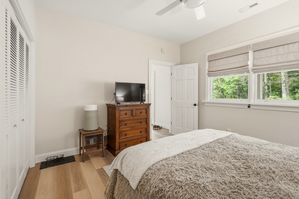 175 Crane Creek Road Young Harris, GA 30582 - Photo 26 of 40 a bedroom with a bed and a flat tv screen on the dresser