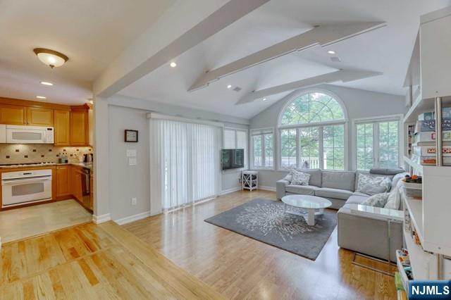 230 Pinelynn Road Glen Rock, NJ 07452 - Photo 3 of 19 a large living room with stainless steel appliances granite countertop furniture and a large window