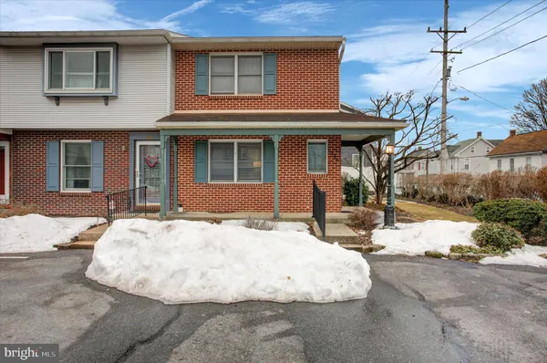a view of a house with snow on the road