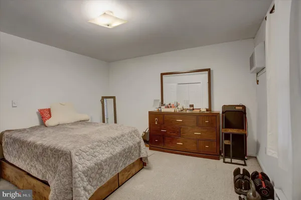 a bedroom with a bed and a desk