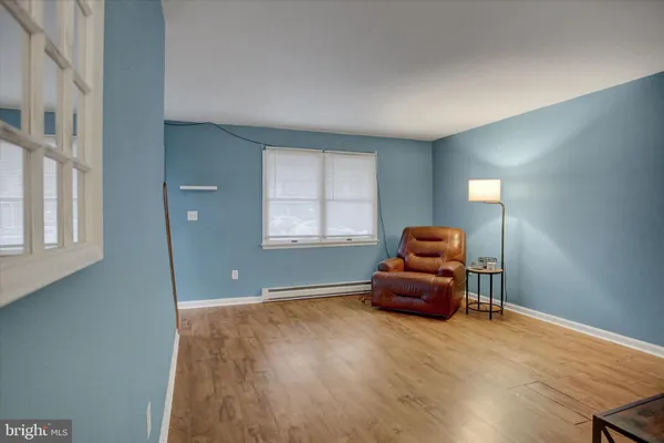a hallway with a couch and a window