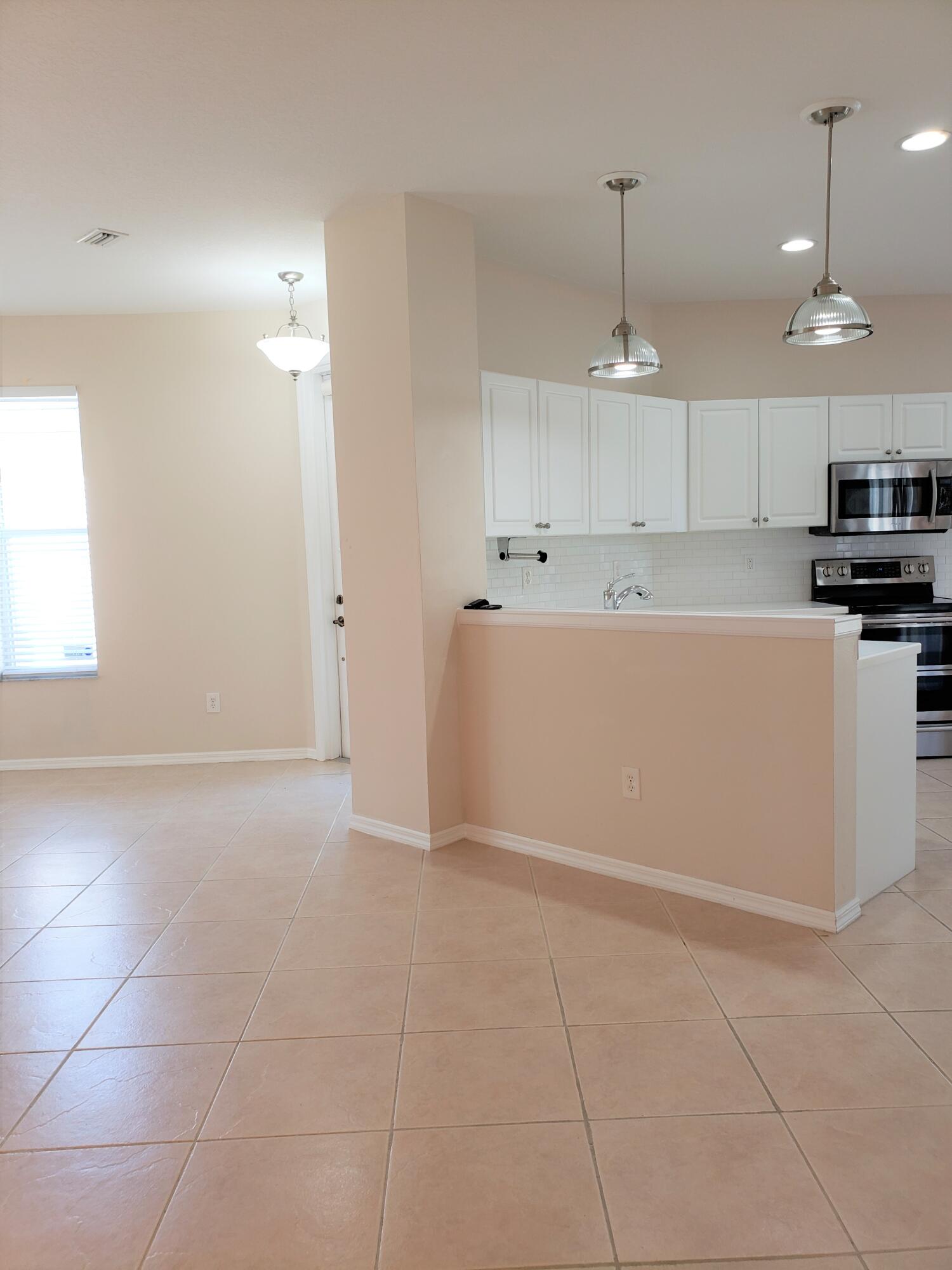 357 Southwest Coconut Key Way Port St. Lucie, FL 34986 - Photo 13 of 56 a view of a kitchen with electric appliances