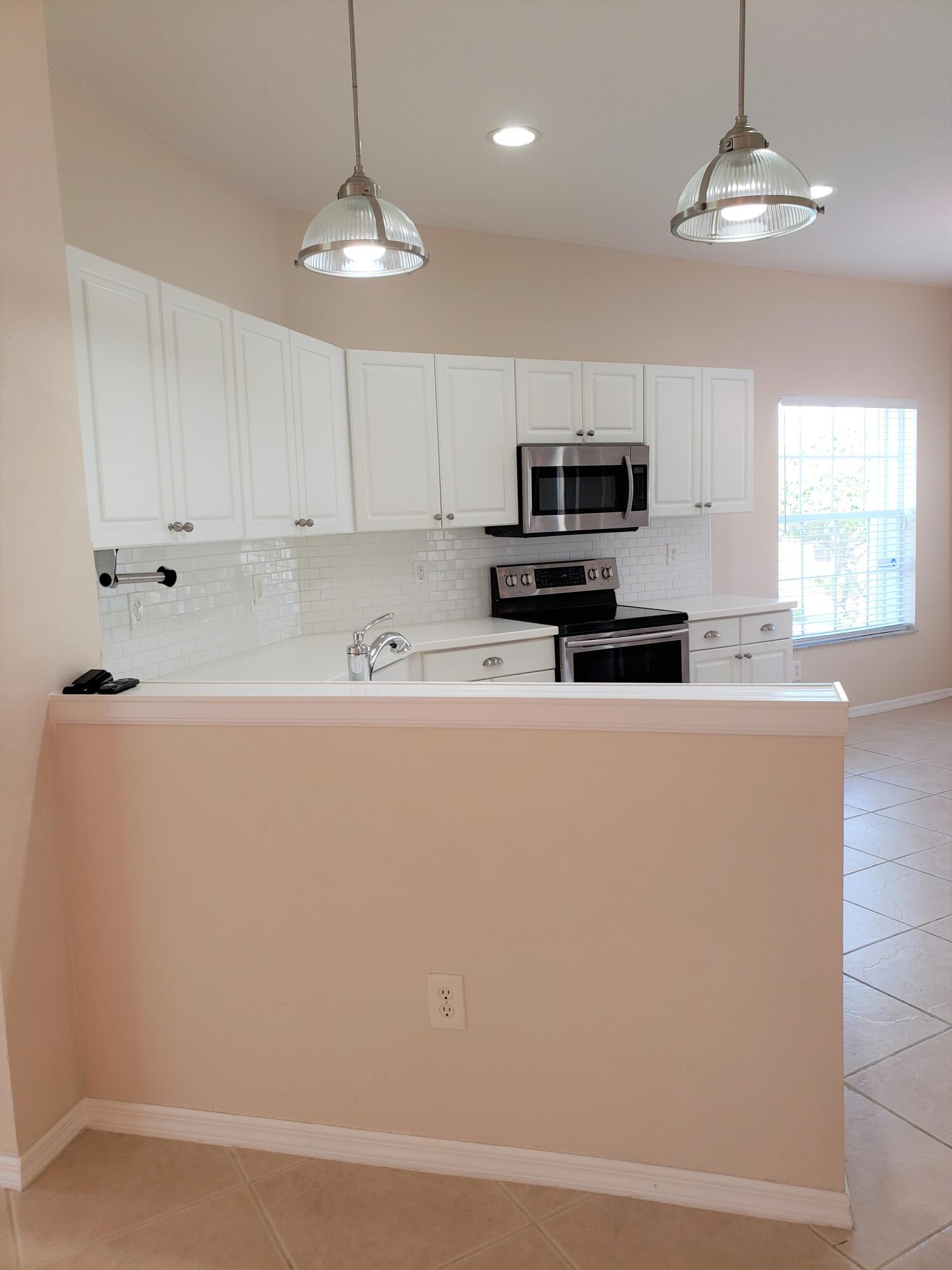 357 Southwest Coconut Key Way Port St. Lucie, FL 34986 - Photo 14 of 56 a kitchen with stainless steel appliances a refrigerator sink and microwave