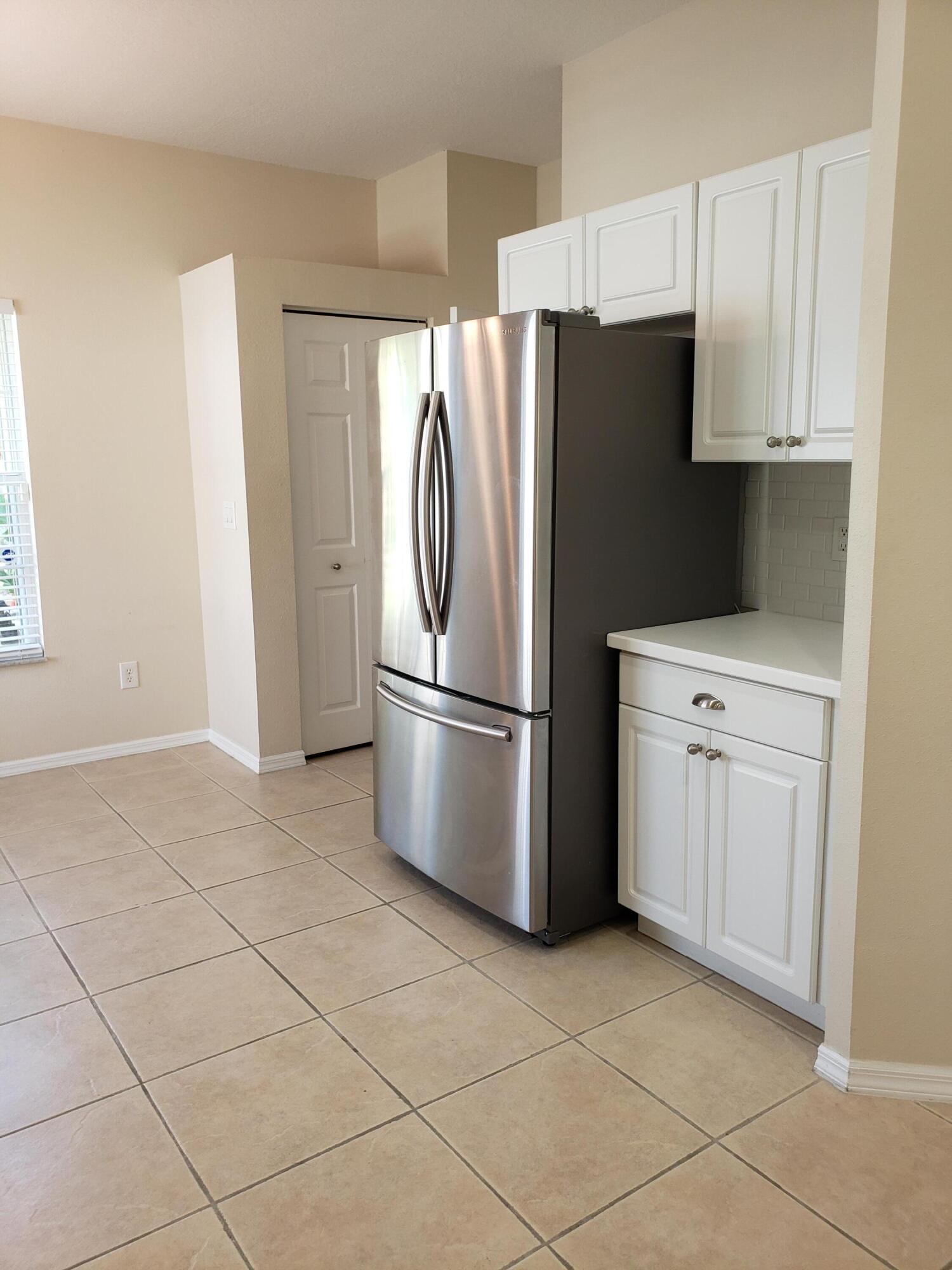 357 Southwest Coconut Key Way Port St. Lucie, FL 34986 - Photo 20 of 56 a kitchen with stainless steel appliances a refrigerator sink and microwave