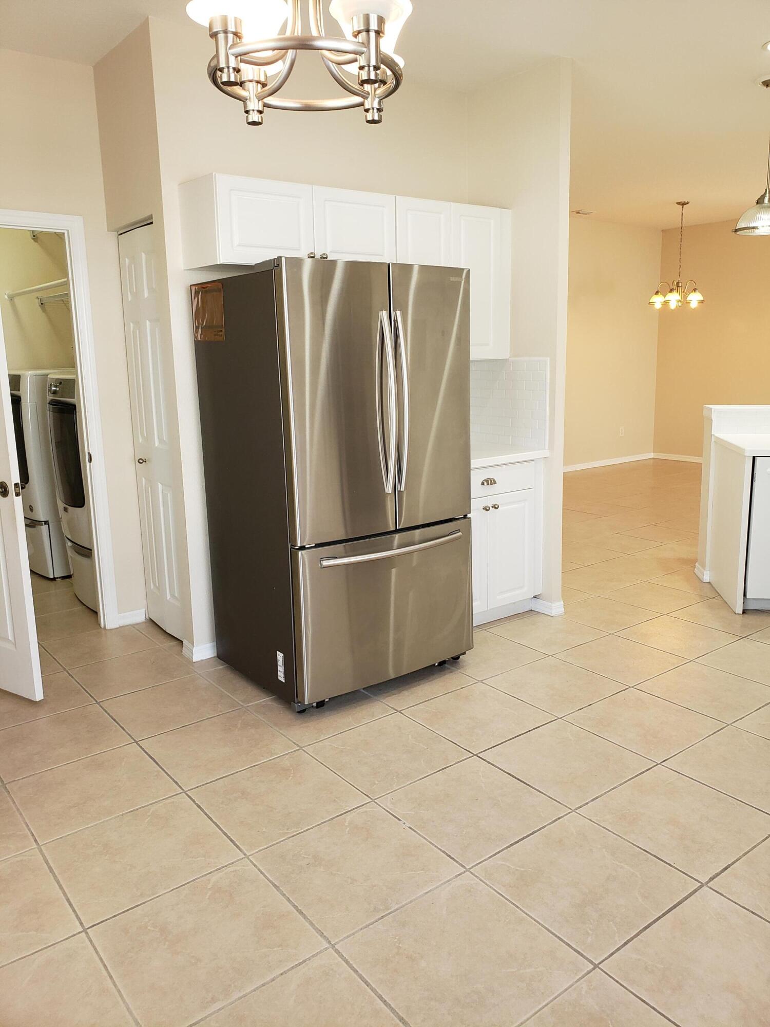 357 Southwest Coconut Key Way Port St. Lucie, FL 34986 - Photo 21 of 56 a kitchen with stainless steel appliances a refrigerator and a counter top space