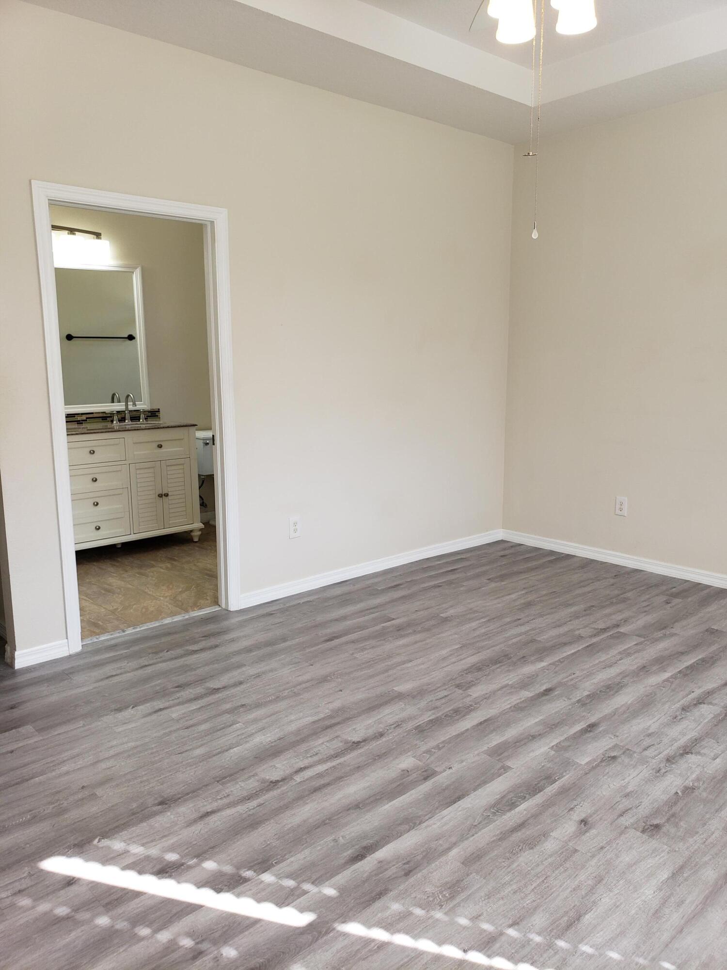 357 Southwest Coconut Key Way Port St. Lucie, FL 34986 - Photo 24 of 56 a view of a room with wooden floor and a sink