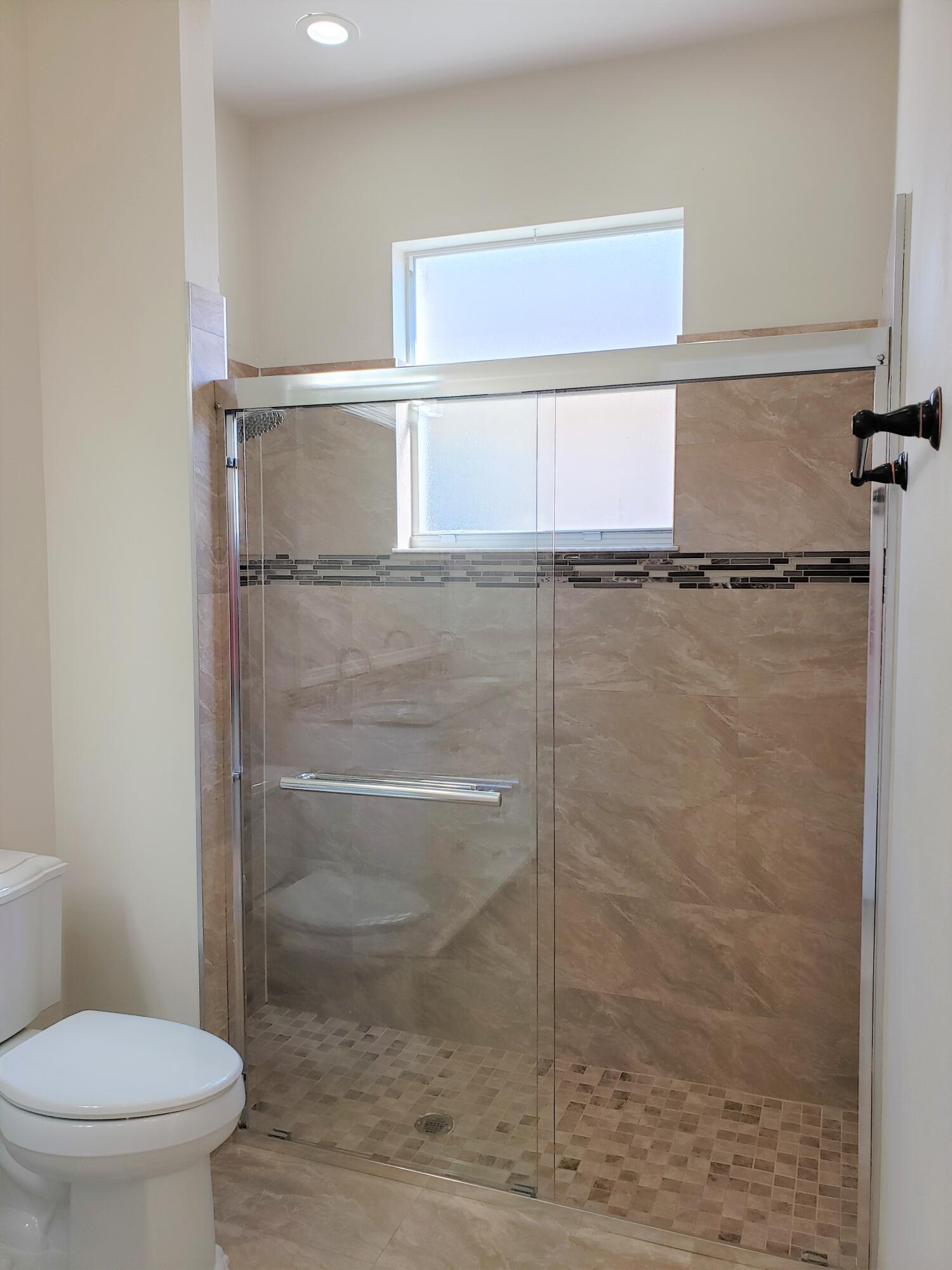 357 Southwest Coconut Key Way Port St. Lucie, FL 34986 - Photo 28 of 56 a bathroom with a toilet and a shower