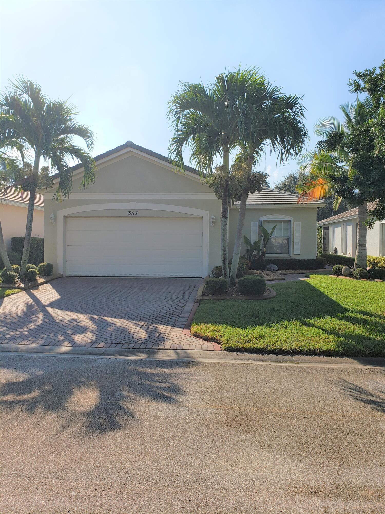 357 Southwest Coconut Key Way Port St. Lucie, FL 34986 - Photo 3 of 56 a front view of house with yard and green space