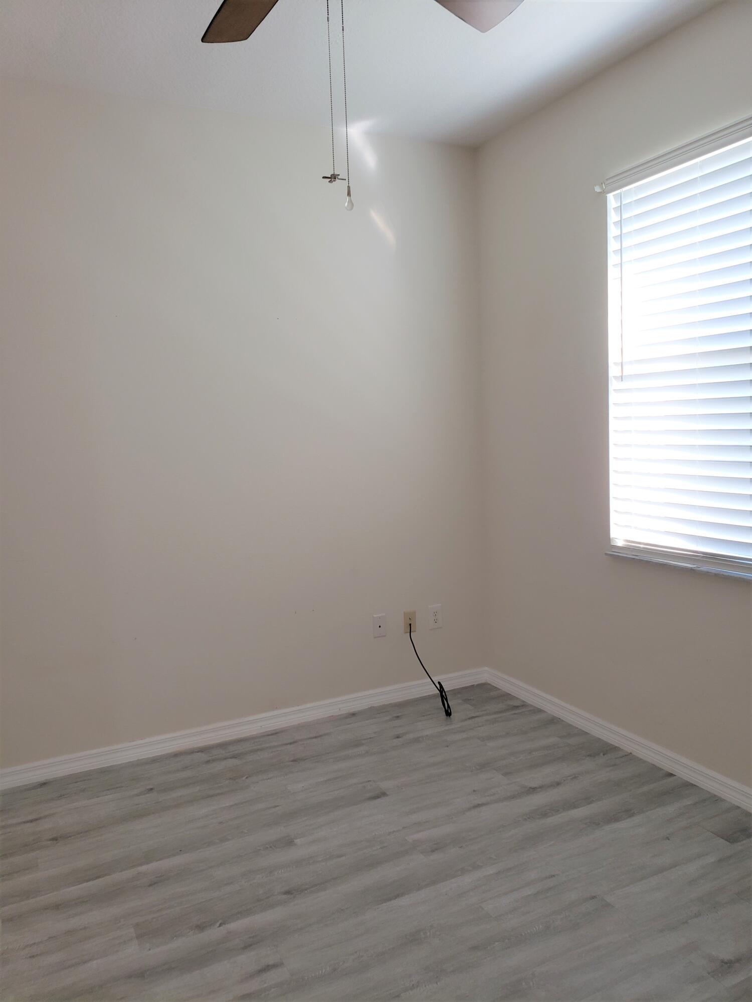357 Southwest Coconut Key Way Port St. Lucie, FL 34986 - Photo 33 of 56 a view of a room with wooden floor and window
