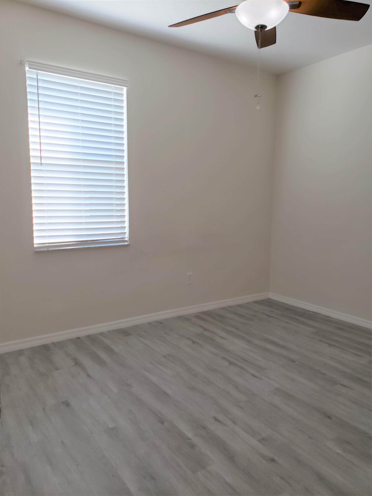 357 Southwest Coconut Key Way Port St. Lucie, FL 34986 - Photo 34 of 56 an empty room with a window