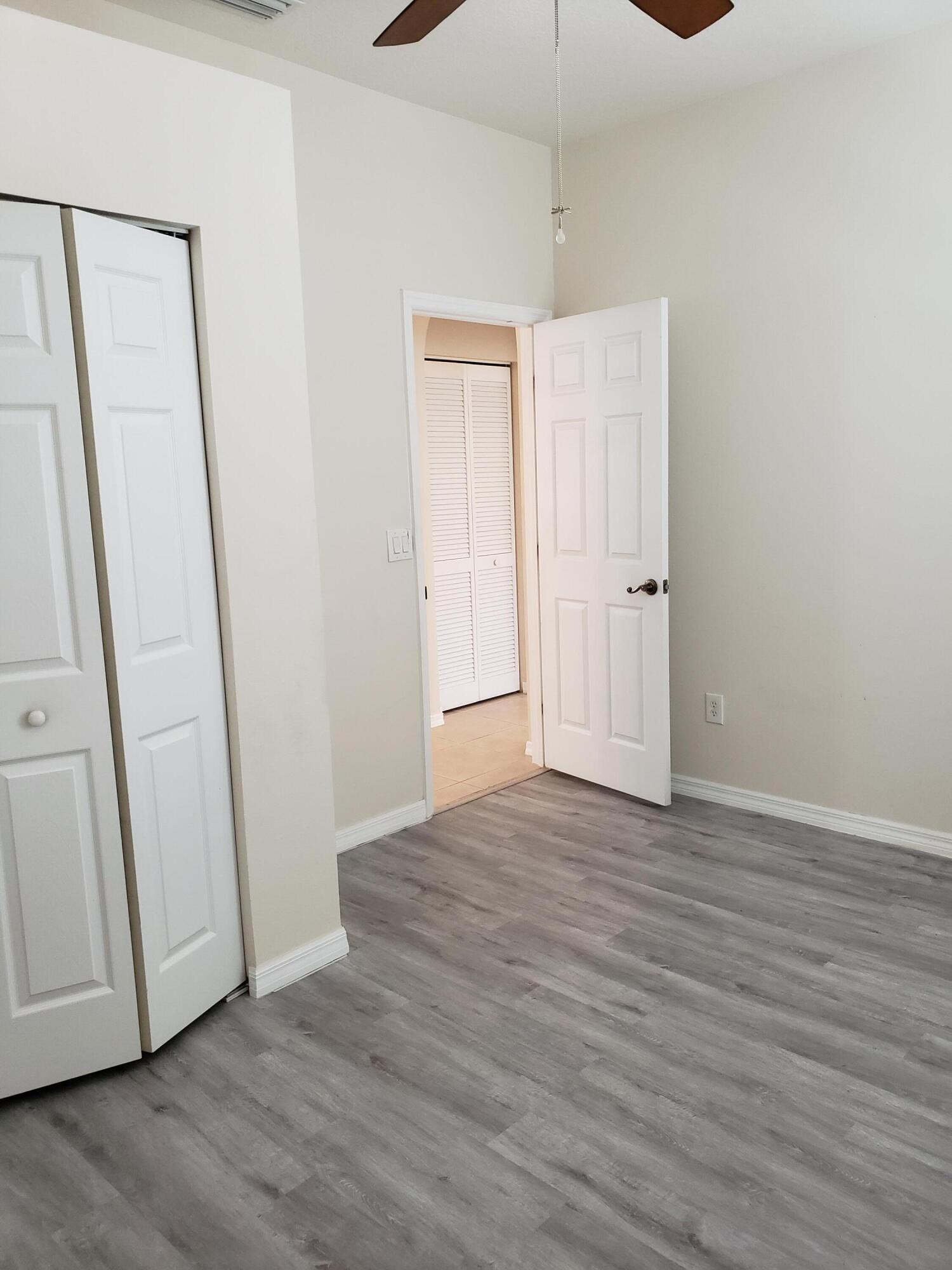 357 Southwest Coconut Key Way Port St. Lucie, FL 34986 - Photo 35 of 56 a view of an empty room with wooden floor