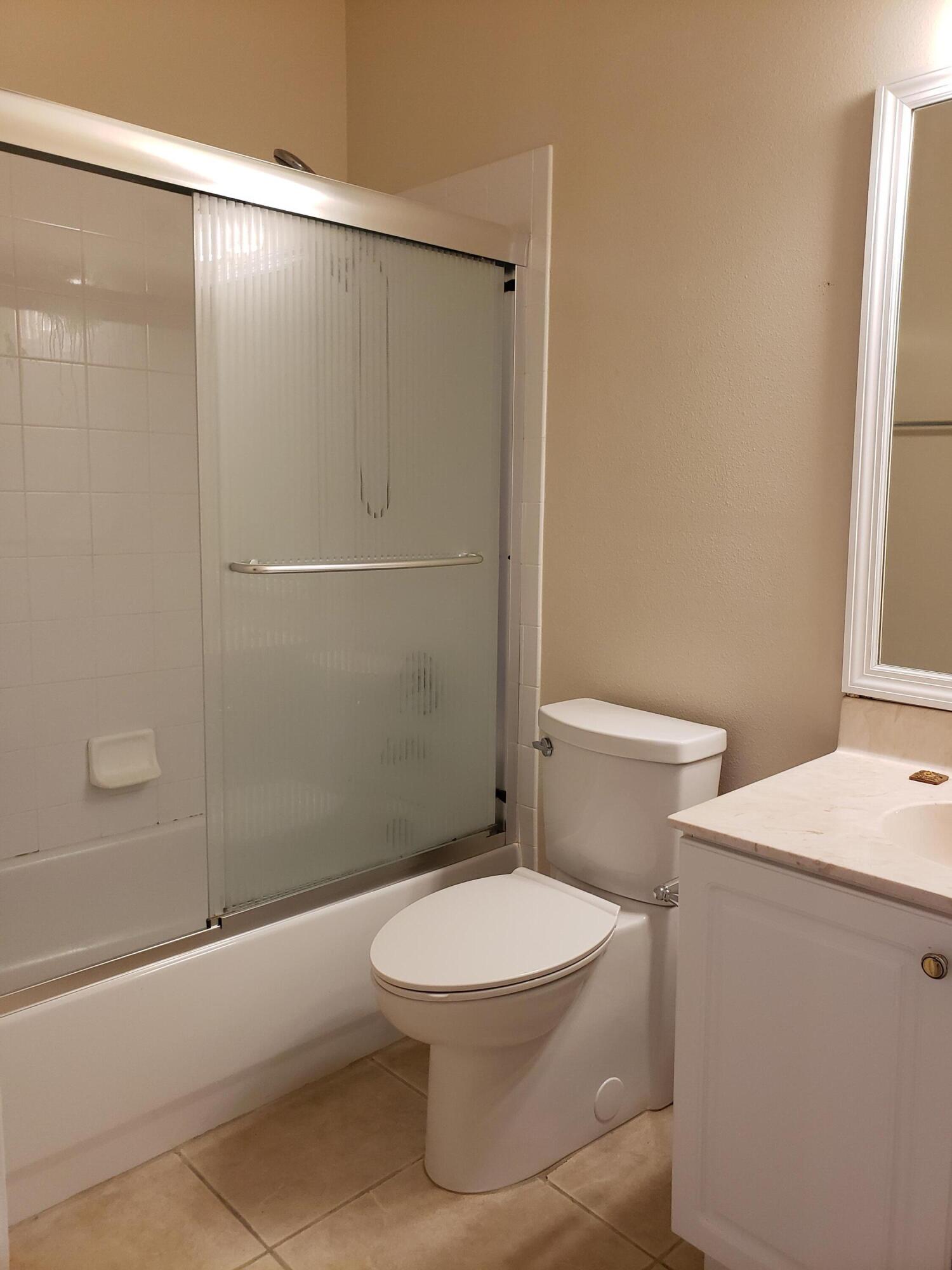 357 Southwest Coconut Key Way Port St. Lucie, FL 34986 - Photo 38 of 56 a white toilet sitting next to a bath tub