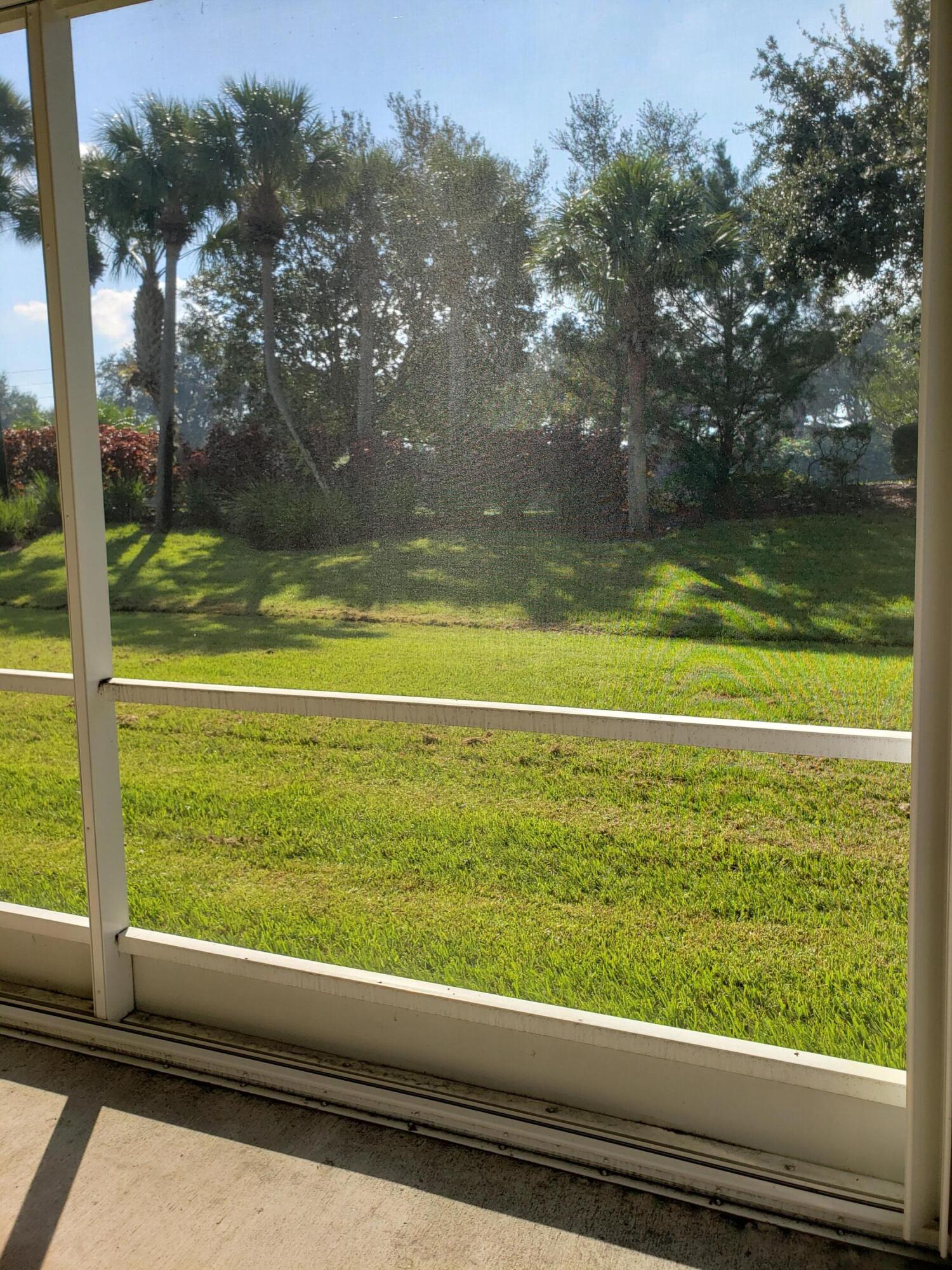 357 Southwest Coconut Key Way Port St. Lucie, FL 34986 - Photo 45 of 56 a view of a yard from a window