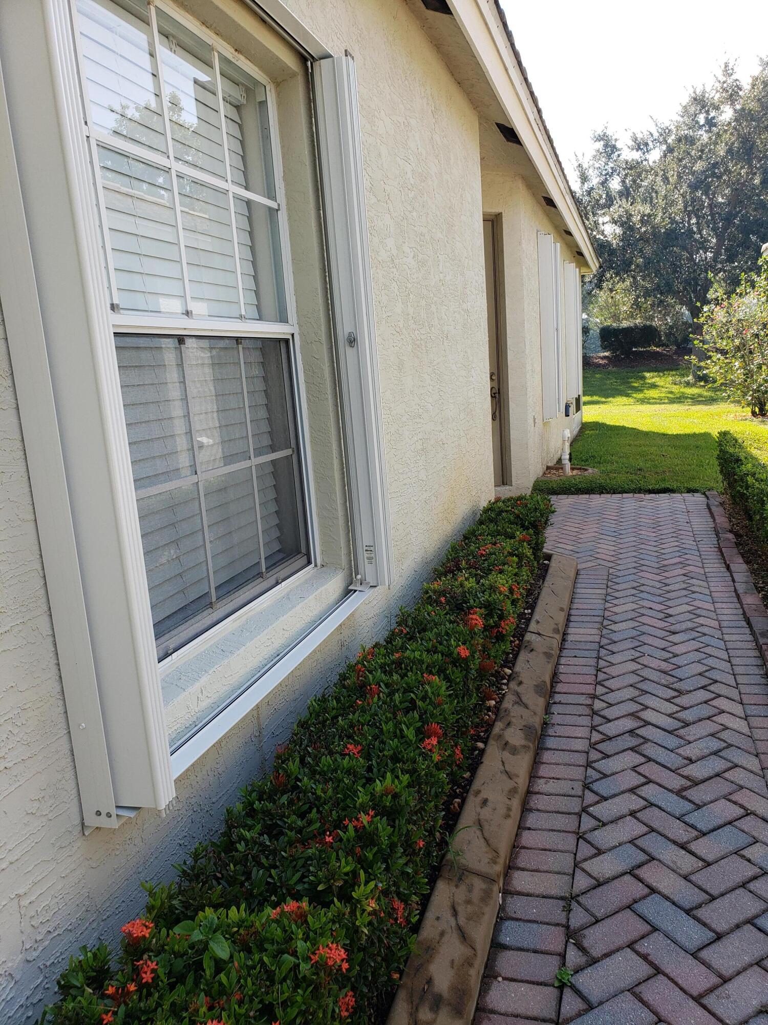 357 Southwest Coconut Key Way Port St. Lucie, FL 34986 - Photo 50 of 56 a view of a pathway besides a house