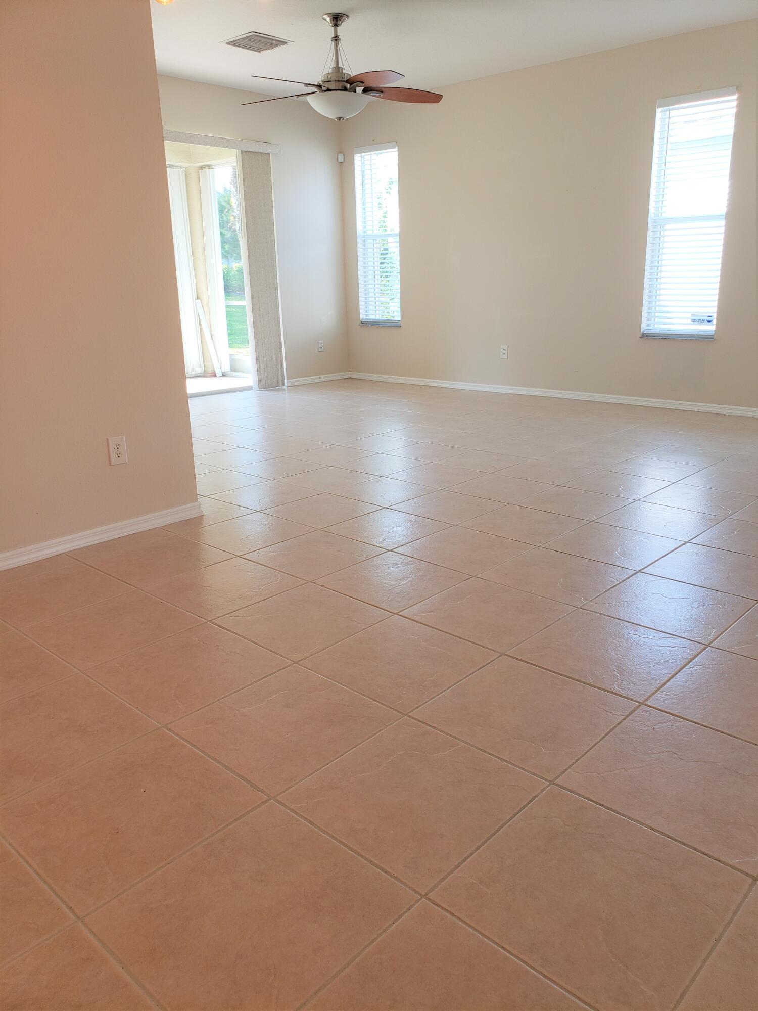 357 Southwest Coconut Key Way Port St. Lucie, FL 34986 - Photo 9 of 56 an empty room with wooden floor and windows