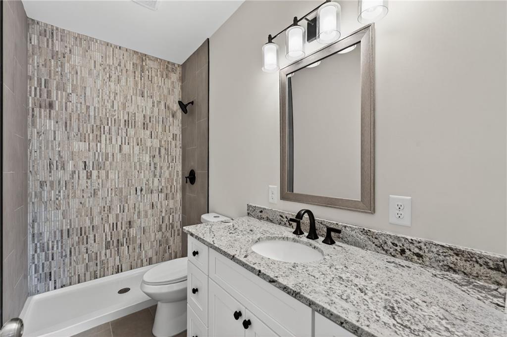 43 Brownlow Drive Northwest Rome, GA 30165 - Photo 12 of 24 a bathroom with a granite countertop sink toilet and shower