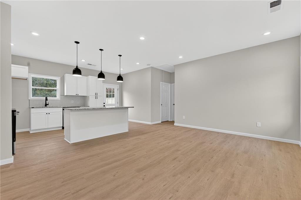 43 Brownlow Drive Northwest Rome, GA 30165 - Photo 5 of 24 a view of kitchen with white cabinets and wooden floor