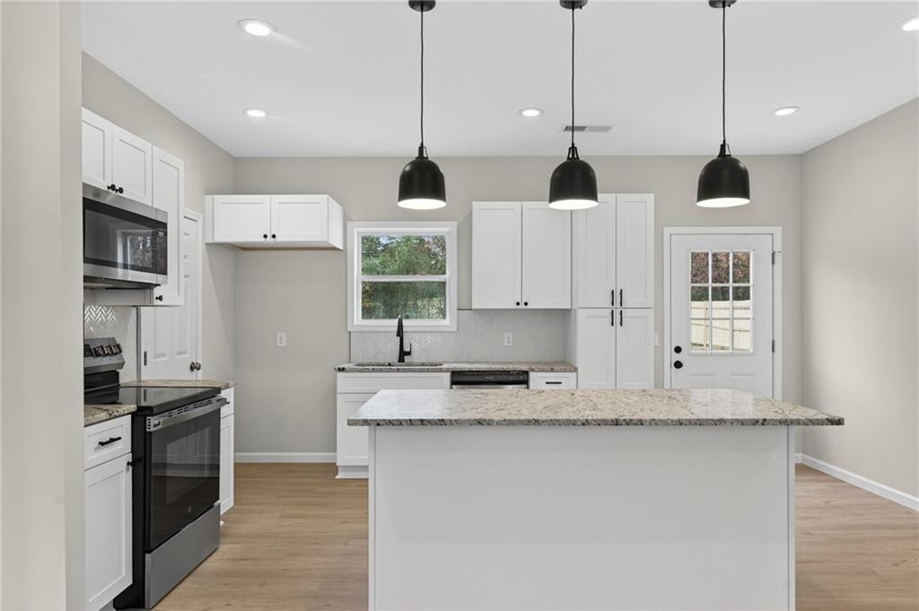 43 Brownlow Drive Northwest Rome, GA 30165 - Photo 6 of 24 a large kitchen with stainless steel appliances granite countertop a sink a stove and a refrigerator