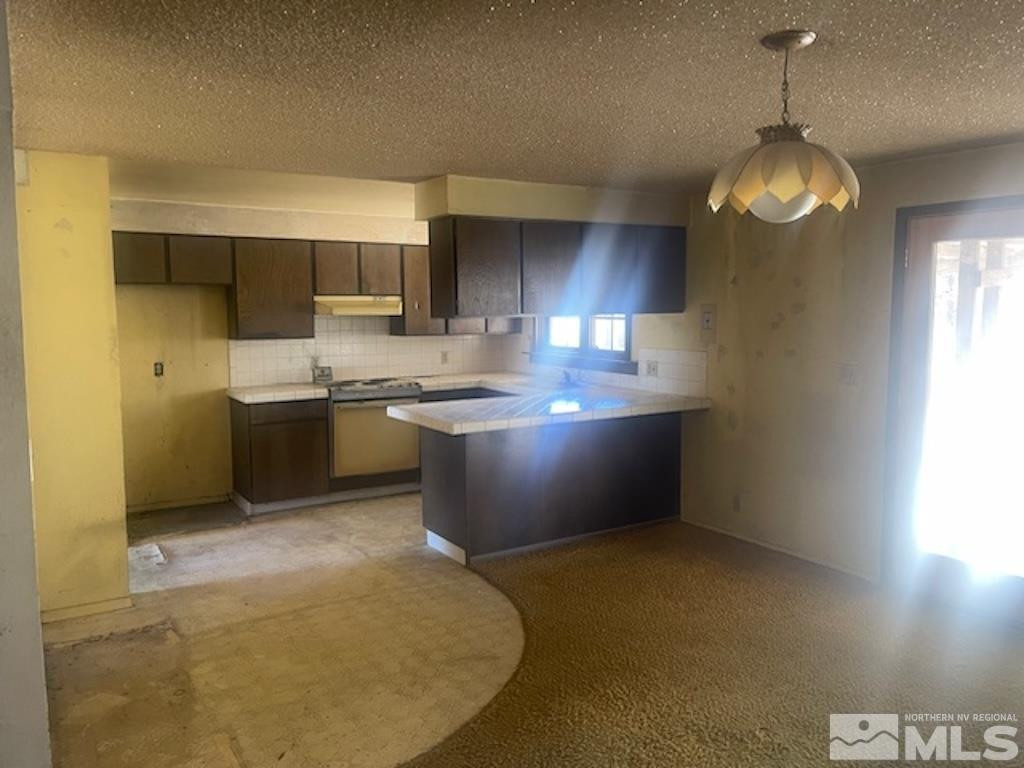 10765 Osage Road Reno, NV 89508 - Photo 14 of 22 a kitchen with stainless steel appliances granite countertop a sink a stove and a refrigerator