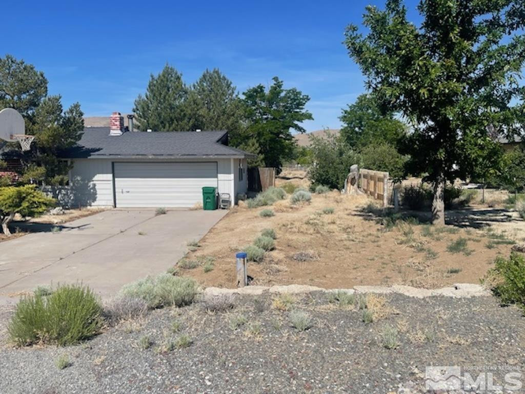 10765 Osage Road Reno, NV 89508 - Photo 3 of 22 a view of white house with a yard