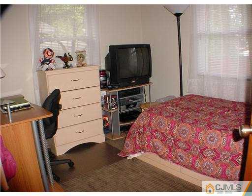 9 Stevens Road Edison, NJ 08817 - Photo 8 of 10 a bedroom with a bed and a flat screen tv