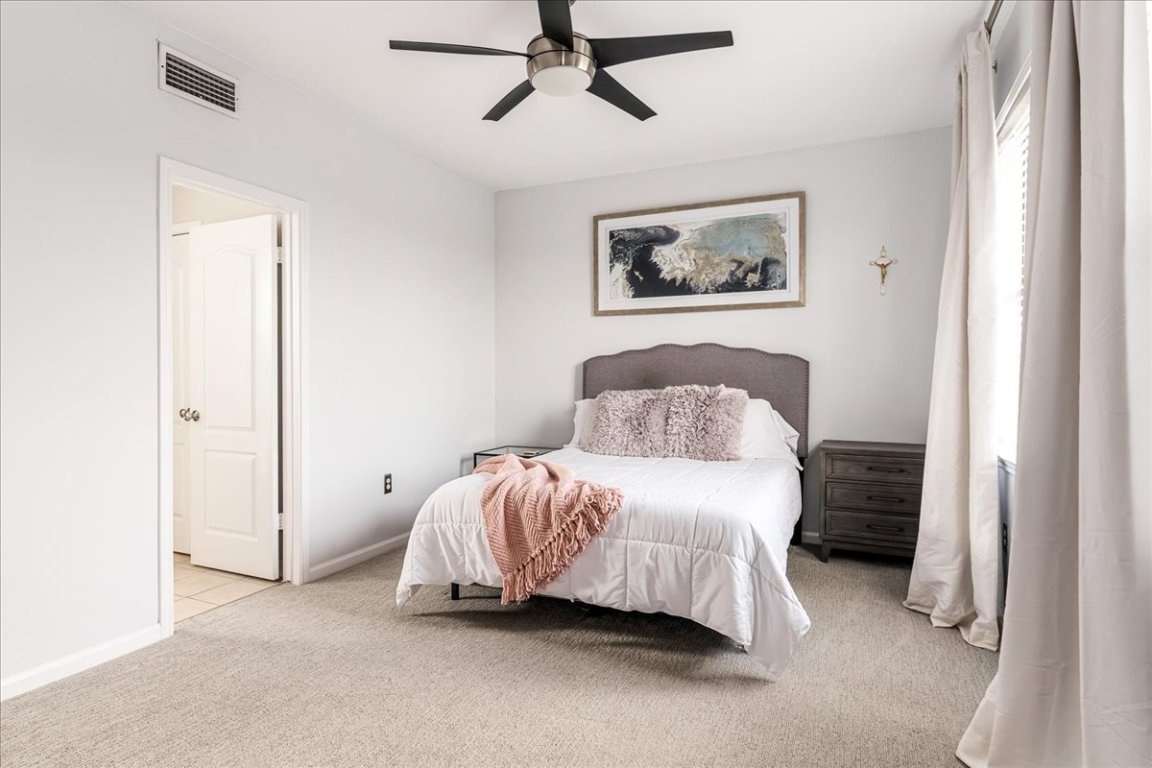 11203 Ranch Road 2222, Unit 1406 Austin, TX 78730 - Photo 11 of 37 a bedroom with a bed and a painting on the wall