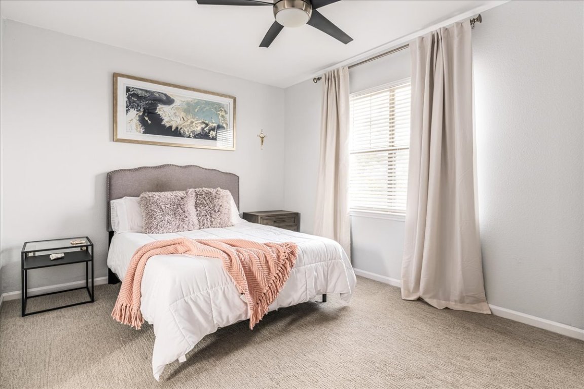 11203 Ranch Road 2222, Unit 1406 Austin, TX 78730 - Photo 12 of 37 a bedroom with a bed and a window