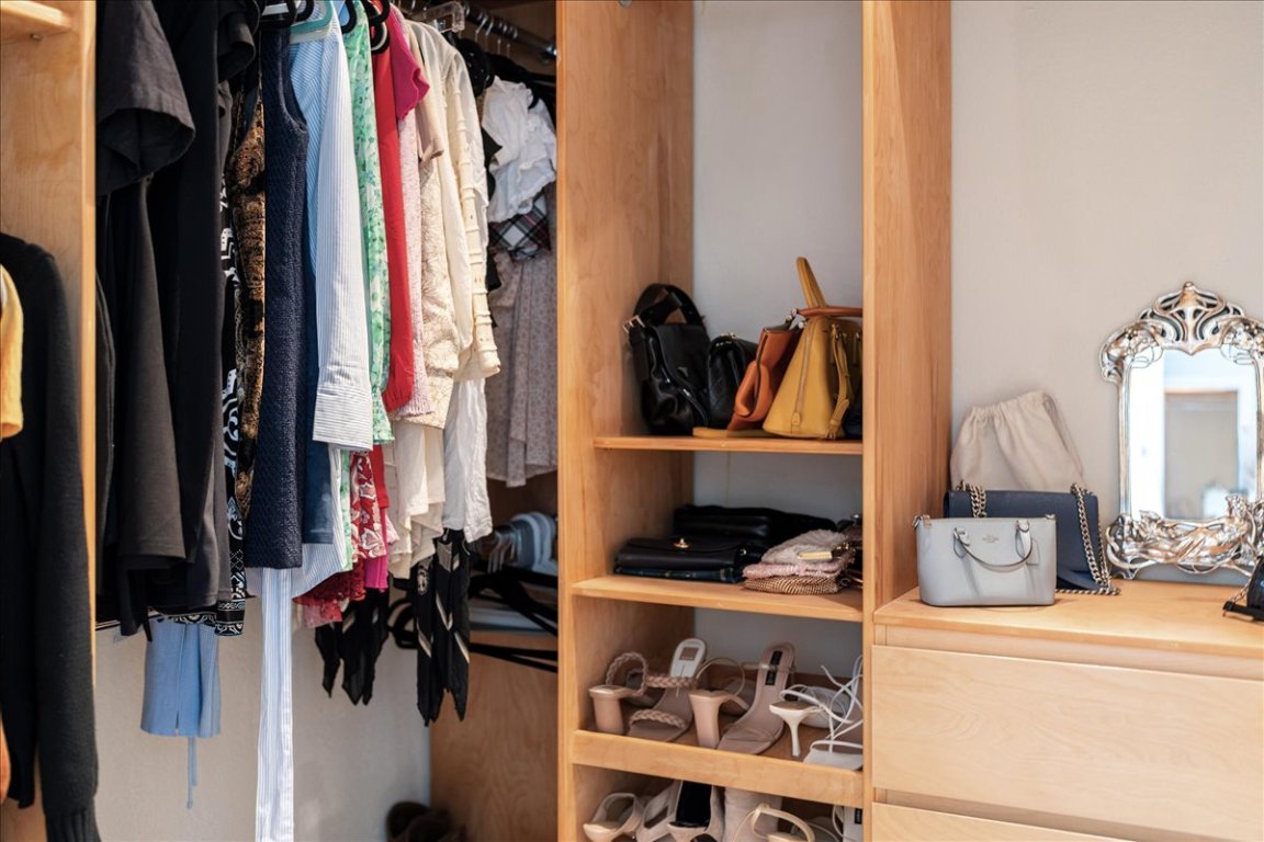 11203 Ranch Road 2222, Unit 1406 Austin, TX 78730 - Photo 14 of 37 a view of walk in closet with clothes and shoes