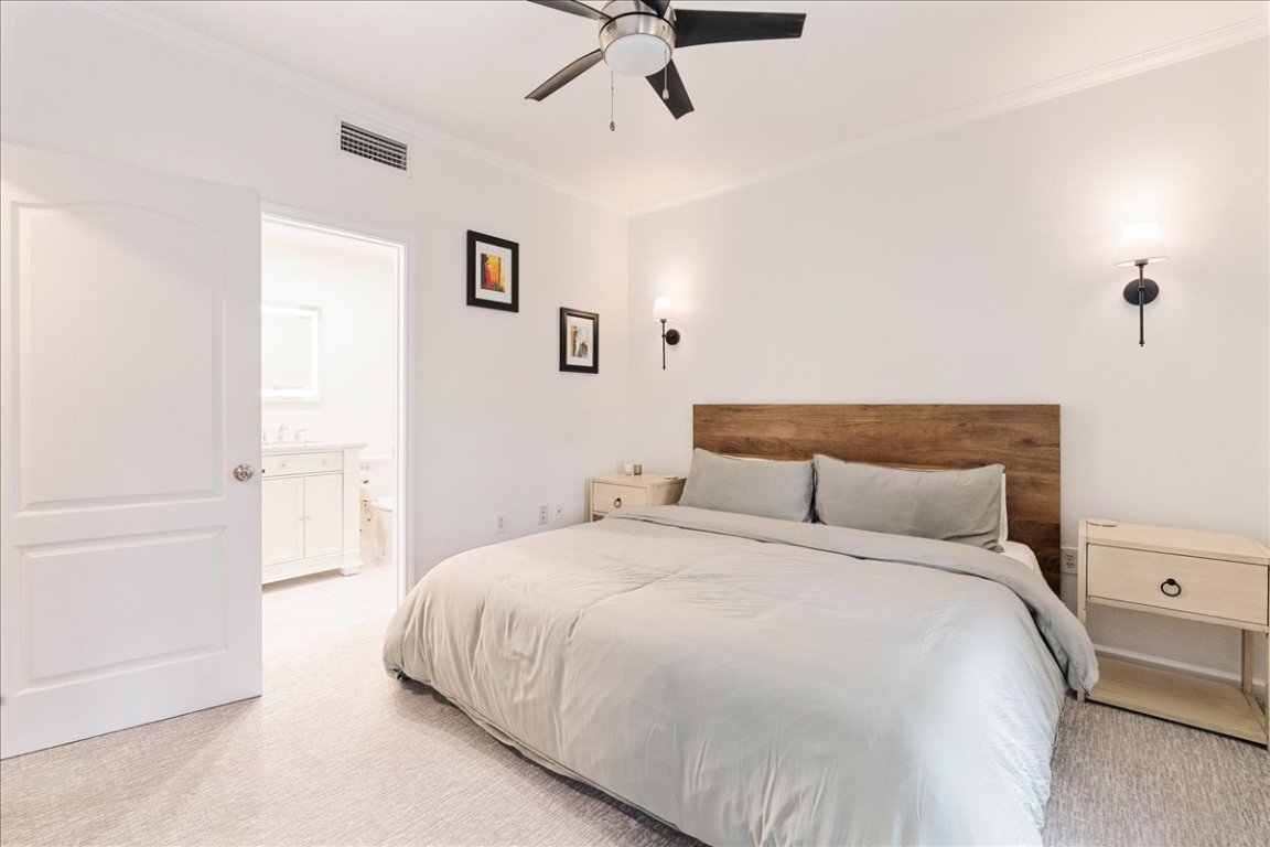 11203 Ranch Road 2222, Unit 1406 Austin, TX 78730 - Photo 26 of 37 a bedroom with a bed and cabinets