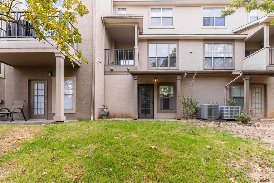 11203 Ranch Road 2222, Unit 1406 Austin, TX 78730 - Photo 32 of 37 a front view of a building with a yard
