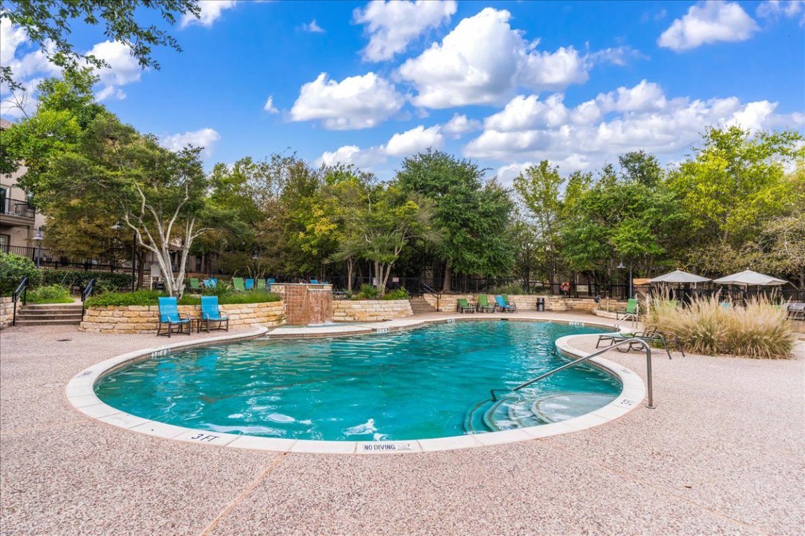 11203 Ranch Road 2222, Unit 1406 Austin, TX 78730 - Photo 34 of 37 a view of a swimming pool with a yard