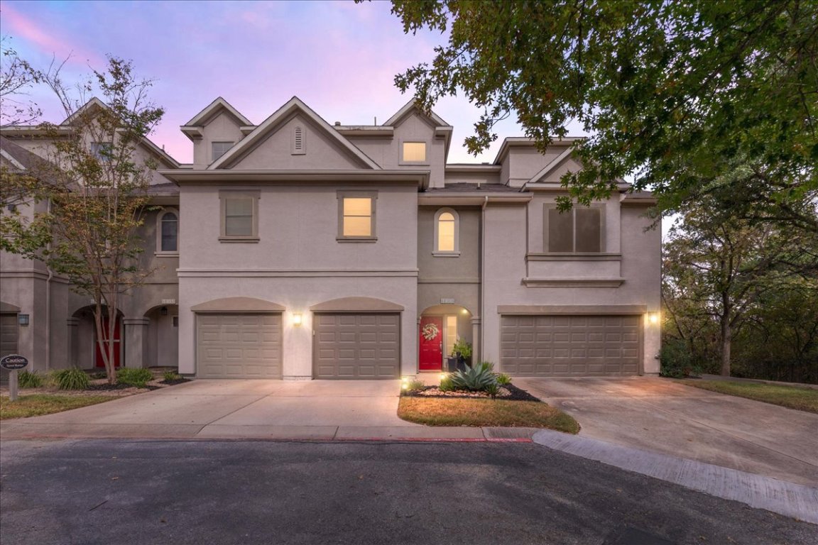 11203 Ranch Road 2222, Unit 1406 Austin, TX 78730 - Photo 37 of 37 a front view of a house with a yard and garage