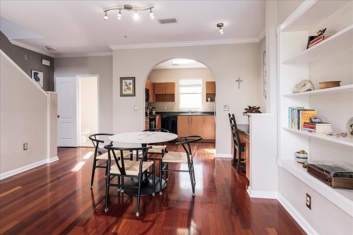 11203 Ranch Road 2222, Unit 1406 Austin, TX 78730 - Photo 10 of 37 a view of a a dining room with furniture a rug and wooden floor
