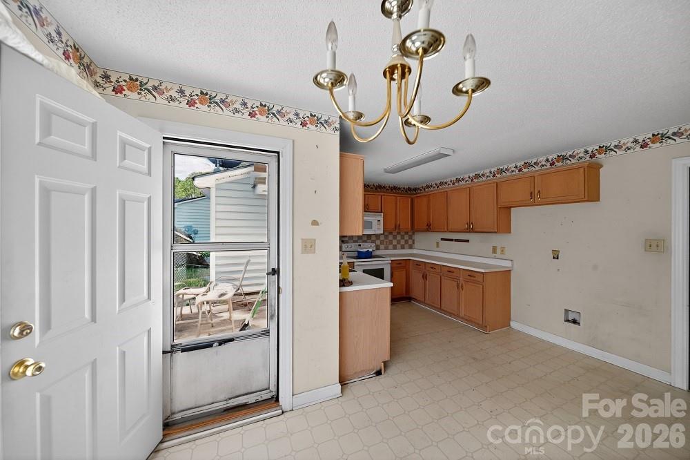 2205 Old Sparta Road Rocky Mount, NC 27804 - Photo 4 of 25 a kitchen with a refrigerator and a sink