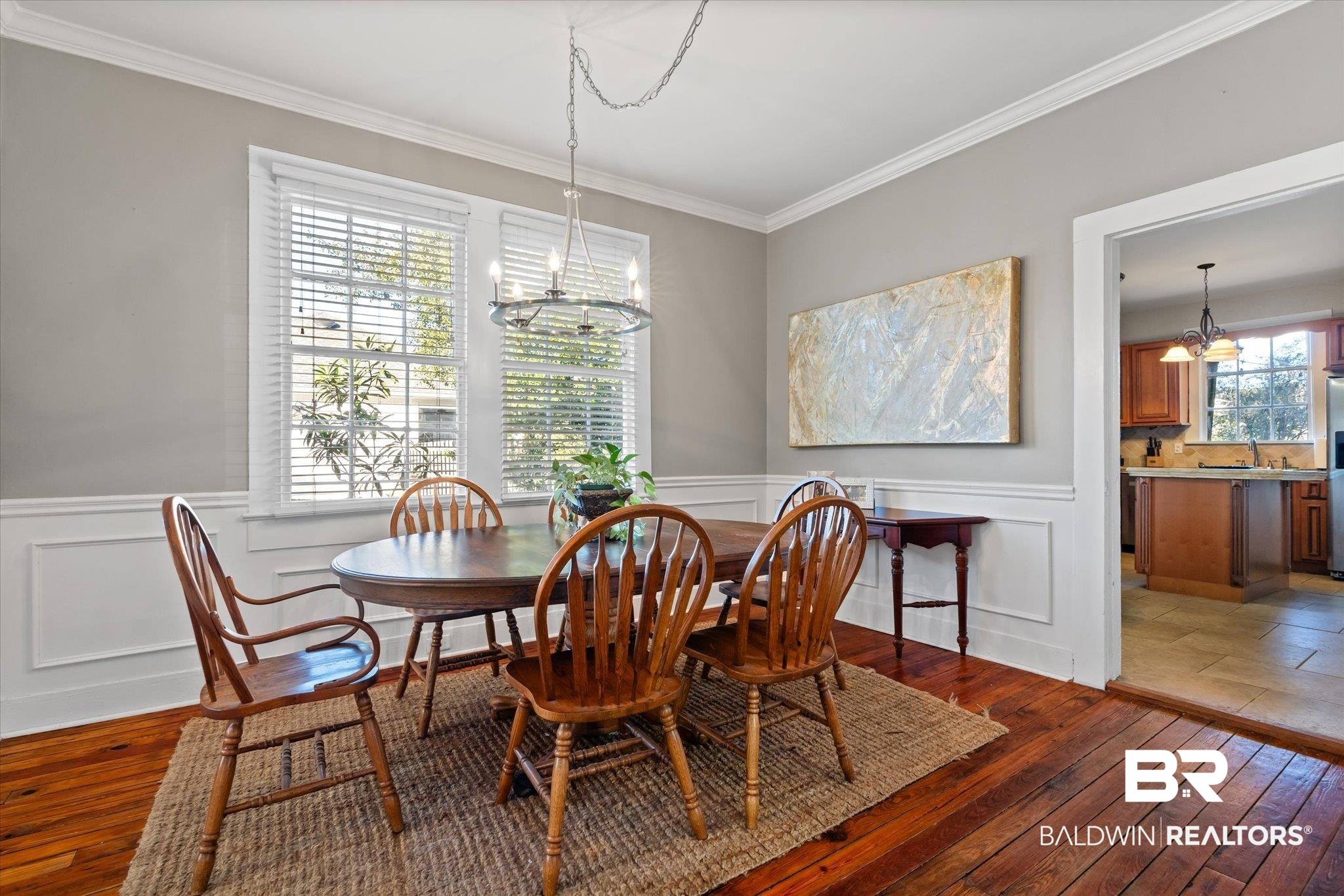 7 Rickarby Place Mobile, AL 36606 - Photo 5 of 20 Dining area featuring crown molding, dark wood-type flooring, a wealth of natural light, and an inviting chandelier