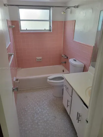 a bathroom with a toilet a sink and bathtub