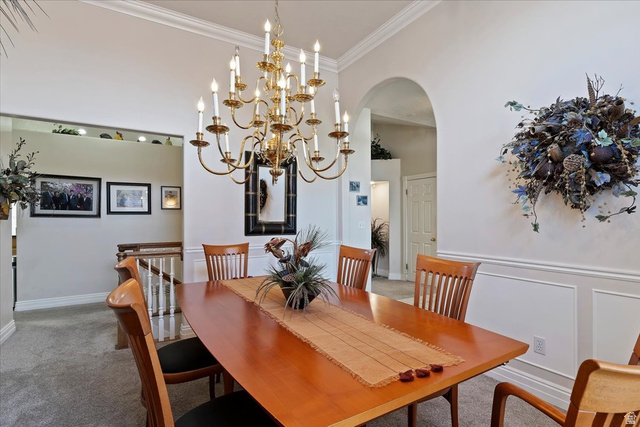 1924 North 2000th Street East Layton, UT 84040 - Photo 11 of 41 Carpeted dining room with arched walkways, ornamental molding, hanging lights, and a high ceiling