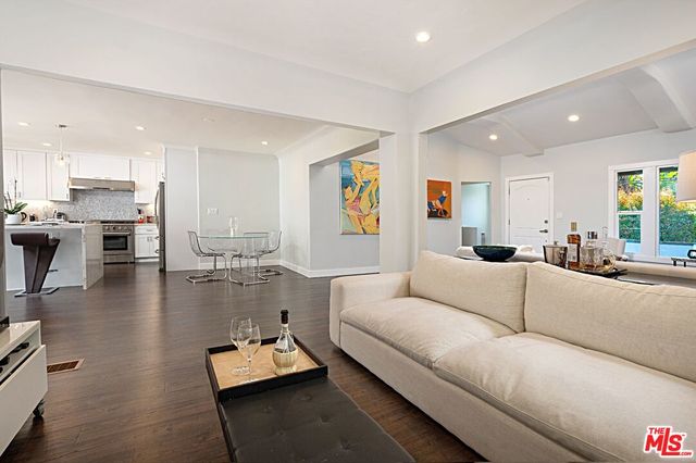 a living room with furniture and floor to ceiling window
